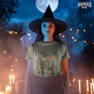 Pumpkin witch PNG featuring a cottage garden with orange pumpkins, cauldron, potion bottles, plants, flowers, and Witchs Herb Garden text.