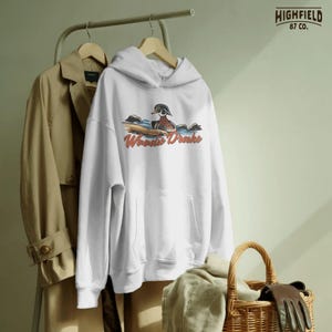 Wood duck hunting PNG showing a drake duck with Woodie Drake lettering, outdoor wildlife design for shirts