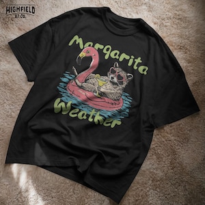 raccoon beach illustration with cocktail drink and float, summer vibes shirt png
