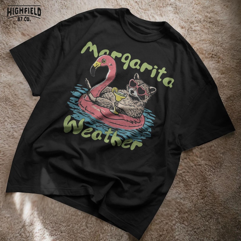 raccoon beach illustration with cocktail drink and float, summer vibes shirt png