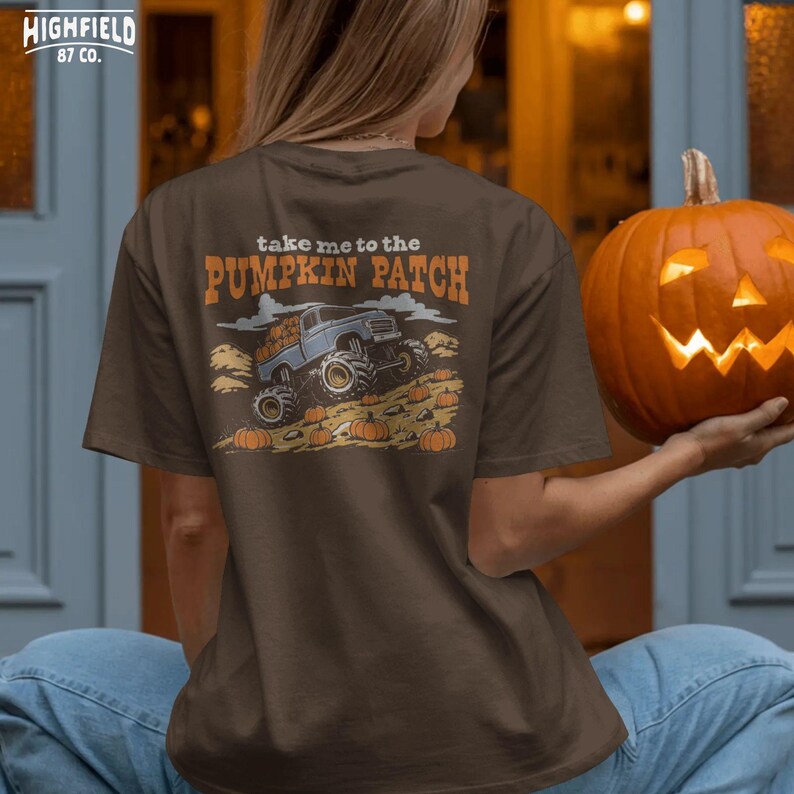 Halloween PNG showing a fun pumpkin patch monster truck scene with pumpkins, autumn field, clouds, and orange seasonal lettering.