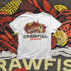 Crawfish boil shirt design PNG displaying detailed red crawfish with yellow corn and sliced lemons arranged in a traditional southern style. Ideal for summer seafood events, Cajun themed parties, and Louisiana inspired shirt printing.