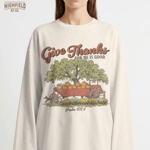 Women faith PNG showing a Christian Thanksgiving design with pumpkin wagon, fall harvest scene, and Psalm 107 1 text.