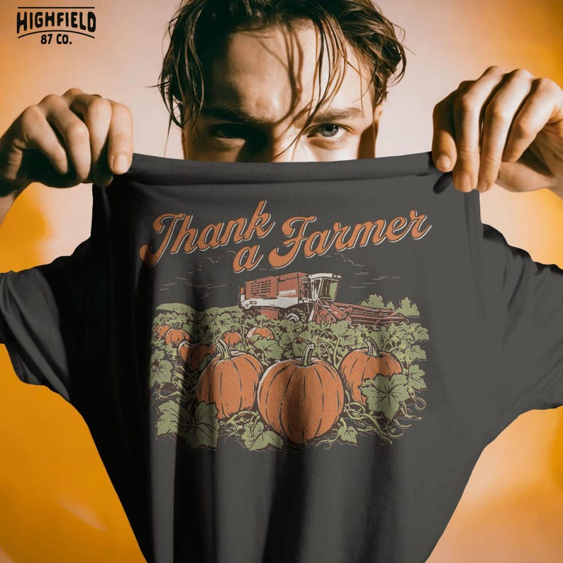 Pumpkin farm PNG showing a harvest field filled with pumpkins and green vines, plus a combine harvester in the distance. The design is finished with “Thank a Farmer” text.