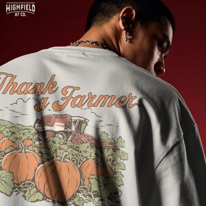 Agriculture PNG showing a vintage style pumpkin patch with large pumpkins, vines, and a combine harvester in the background. The farm artwork reads “Thank a Farmer.”