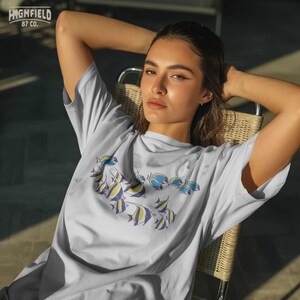 coastal fish png with multiple reef fish swimming together, minimal marine life illustration for beach shirts