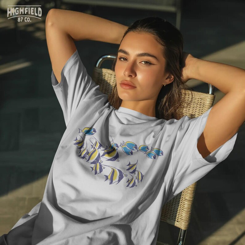 coastal fish png with multiple reef fish swimming together, minimal marine life illustration for beach shirts