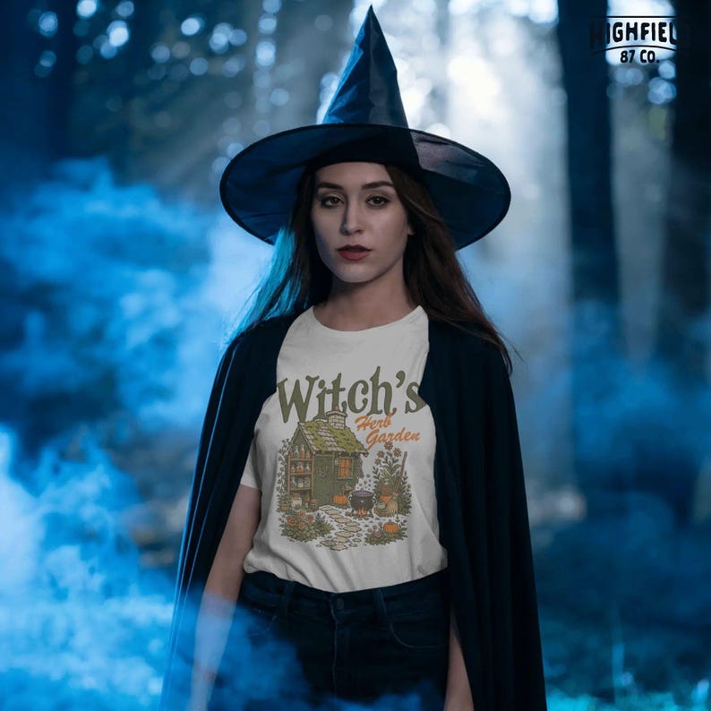 Cute witch PNG featuring Witchs Herb Garden lettering with a tiny cottage, potion jars, cauldron, pumpkins, broom, and garden path.