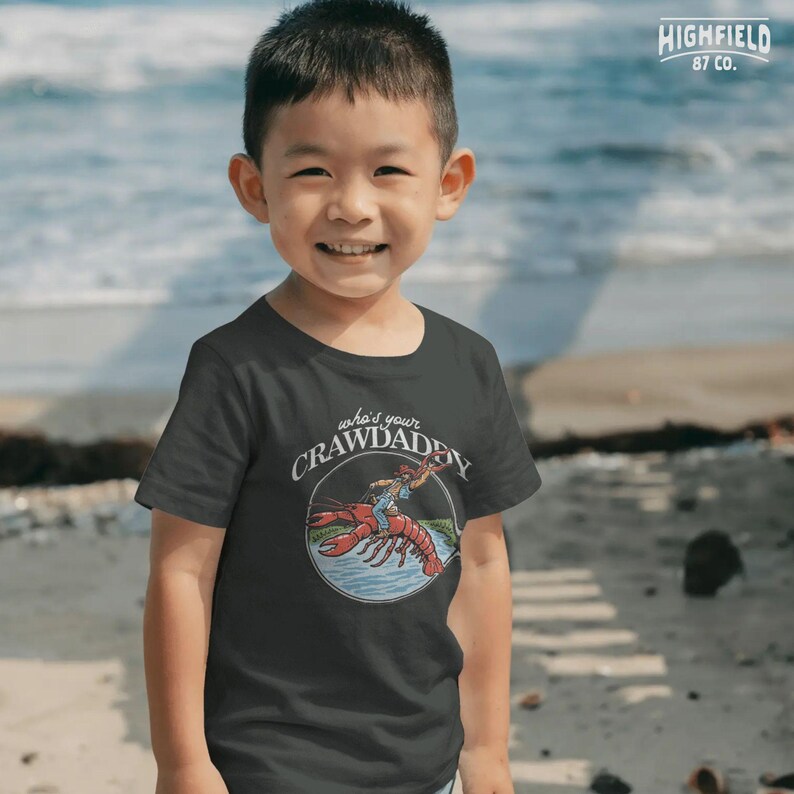 funny fishing crawdad graphic with cowboy rider for unique southern apparel designs