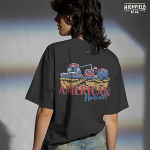 Combine Harvester PNG showing a patriotic harvest scene with farm truck, tractor, and wheat field for farmer apparel and agriculture designs.