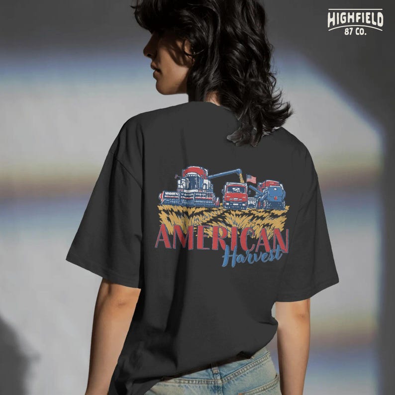 Combine Harvester PNG showing a patriotic harvest scene with farm truck, tractor, and wheat field for farmer apparel and agriculture designs.
