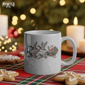 Santa hunting Christmas artwork with mallard ducks pulling a traditional sleigh filled with red, green, and gold presents while snow falls around them.