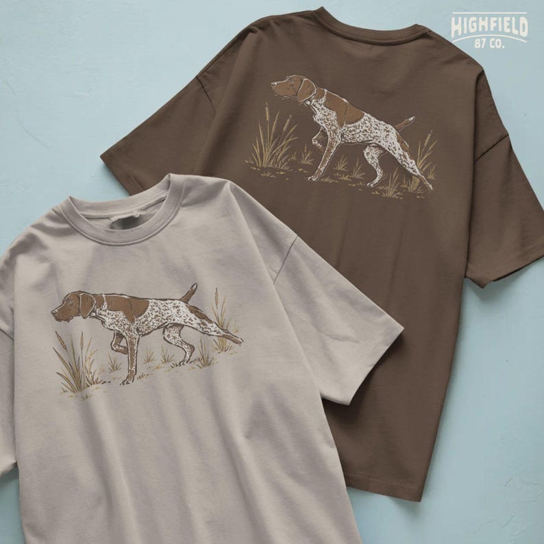 German Pointer PNG featuring a spotted bird dog with brown patches, lifted front paw, straight tail, and natural grass details.