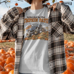 Truck lover PNG featuring a blue monster truck loaded with pumpkins in a fall pumpkin patch scene for kids and boys shirts.