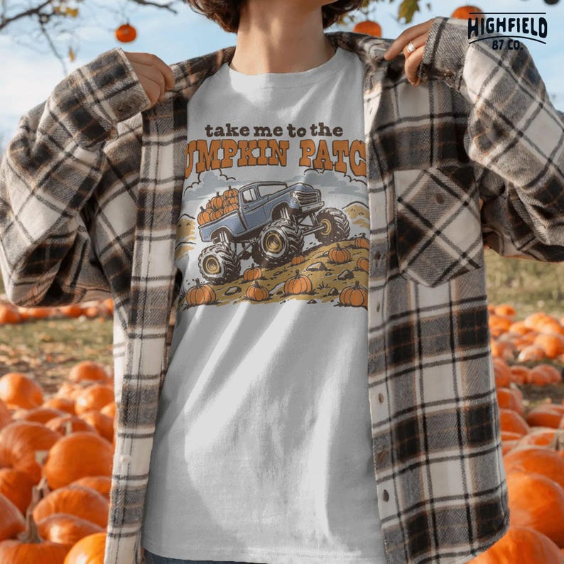 Truck lover PNG featuring a blue monster truck loaded with pumpkins in a fall pumpkin patch scene for kids and boys shirts.