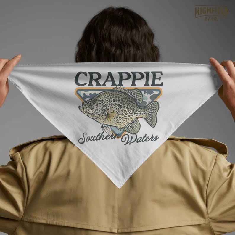 Southern fishing PNG showing a crappie fish badge design with camo pattern, orange border, and freshwater angler theme for shirt graphics.