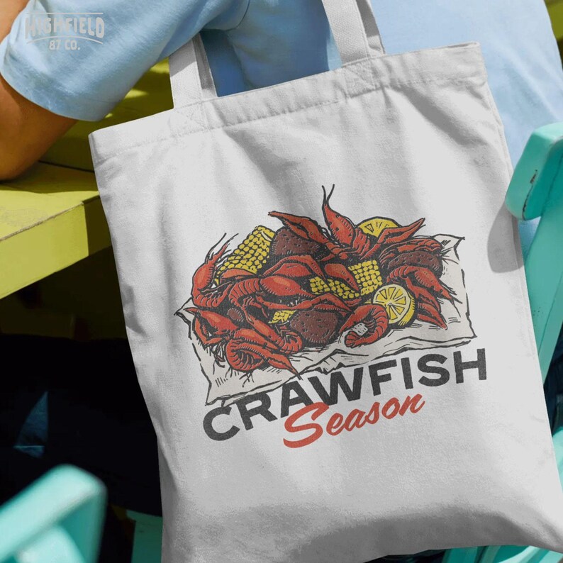 Louisiana crawfish boil illustration showing detailed shell texture and bright yellow corn pieces arranged in a bold layout. Designed as a high resolution PNG for shirt printing and summer party merchandise.
