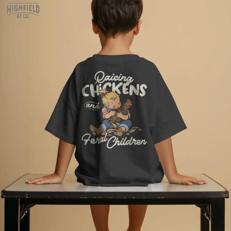 Homestead PNG showing a farm kid cuddling a hen with funny chicken family phrase for backyard chicken shirts.