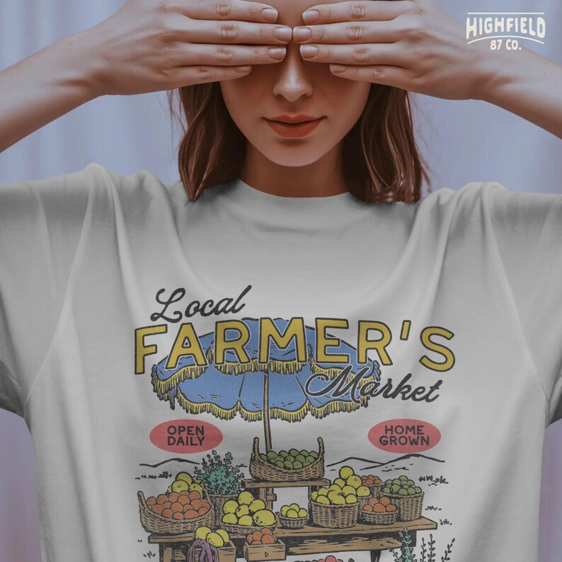 Garden lover PNG showing a hand-drawn farmers market stand with fruit baskets, plant pot, and homegrown produce theme for apparel projects.