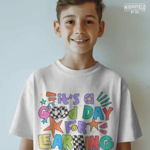 Teacher shirt PNG with a cheerful school quote, colorful star elements, and bold doodle letters for classroom style graphics.