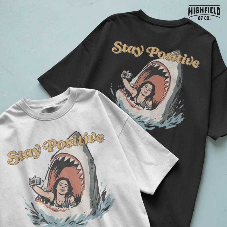 humorous shark design with woman inside shark mouth taking selfie, stay positive text in bold style, funny ocean png graphic for beach shirts and summer apparel