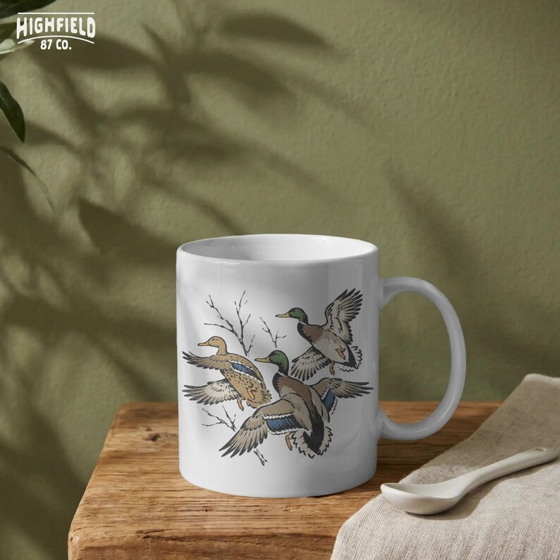 Bird hunting PNG illustration with mallard ducks in flight and tree branch details on a light background.