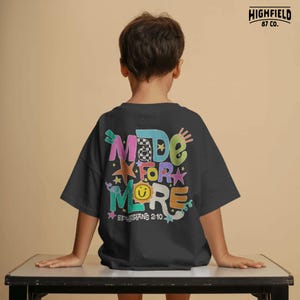 Positive kids PNG featuring bright doodle letters and Ephesians 2:10 scripture for encouraging Christian school apparel.