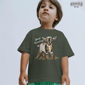 Goat shirt design PNG featuring a young goat in a hand drawn style with hay beneath its feet and a funny pun caption for farm animal lovers.