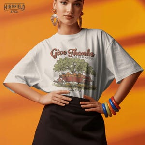 Christian fall PNG featuring a red farm wagon full of pumpkins with Give Thanks text for Thanksgiving shirt designs.
