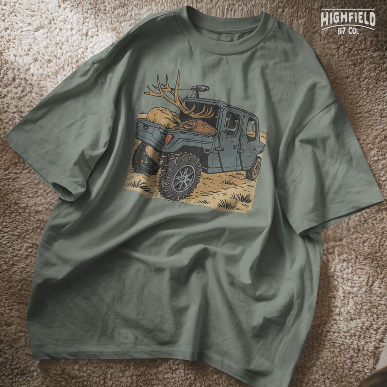 Side profile of a camo-painted UTV holding an elk body with antlers in its bed. This elk hunting PNG design is used in deer season digital downloads for hunters making t-shirts, stickers, or outdoor logbook pages.