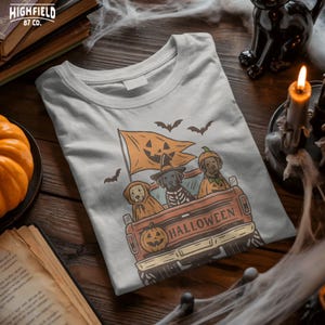 Halloween truck PNG for dog lovers showing three dogs dressed for spooky season riding in the back of a pickup truck.