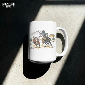 Digital download PNG featuring a team roping rodeo cowboy scene with horse, steer, lasso, dust, and desert ranch artwork.