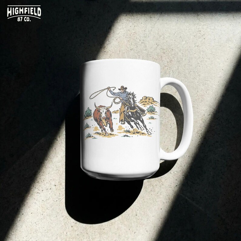 Digital download PNG featuring a team roping rodeo cowboy scene with horse, steer, lasso, dust, and desert ranch artwork.