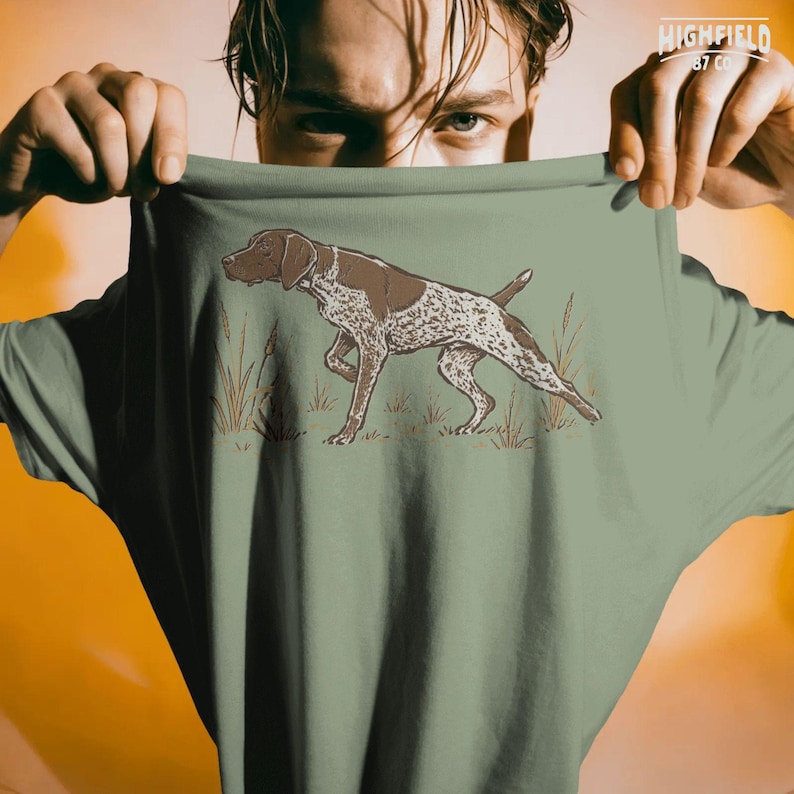 Dog lover PNG featuring a German Shorthaired Pointer hunting dog in a natural outdoor field pose with detailed spotted coat.