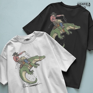 Cowboy alligator PNG showing ranch style humor with cowboy riding wild gator