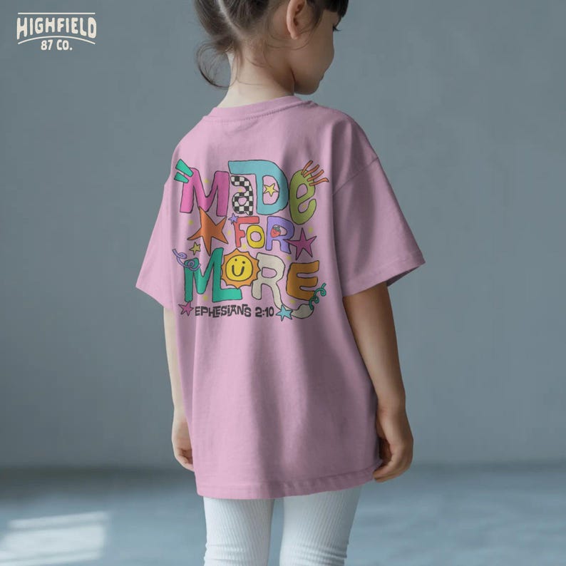 Teacher shirt PNG showing bright Made For More lettering with Bible verse text for Christian school and classroom apparel.