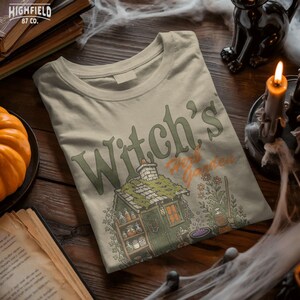 Spooky season PNG showing a Halloween witch cottage with herb shelves, cauldron, pumpkins, flowers, and hand drawn fall details.