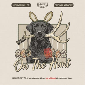 May include: A vintage-style illustration features a black Labrador with bunny ears, holding an antler. Camouflage Easter eggs hang below. The text "On The Hunt" is displayed in a decorative font.