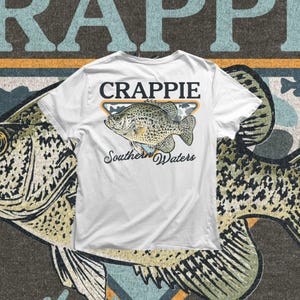 Freshwater fishing PNG showing a crappie fish with spotted body details, bold Crappie text, and southern outdoor style for digital shirt designs.