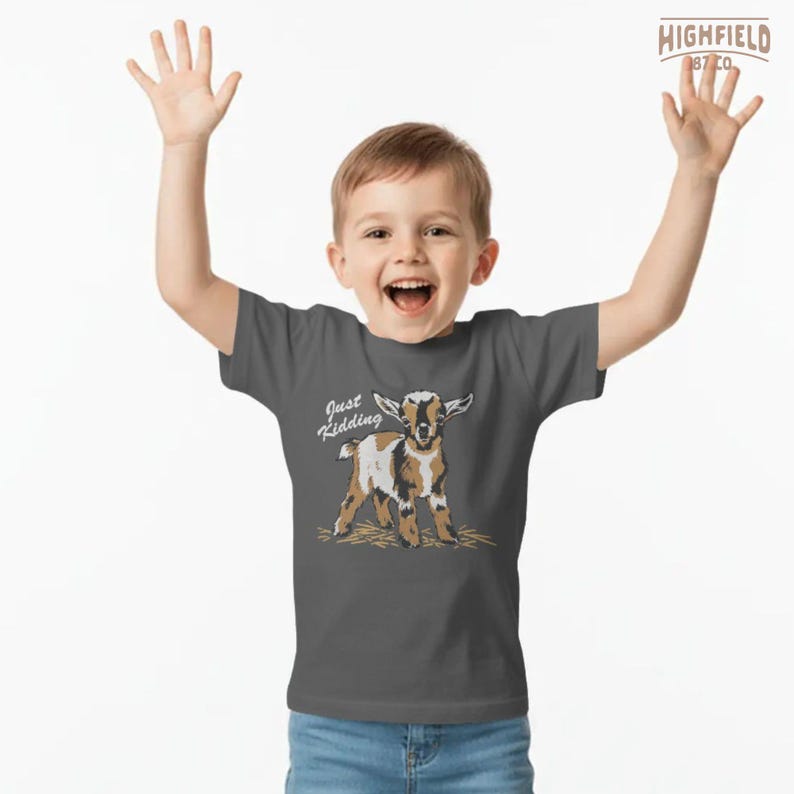 Cute goat PNG showing a baby farm goat with a playful “Just Kidding” phrase, created for sublimation shirts, boutique apparel, and rural themed gifts.