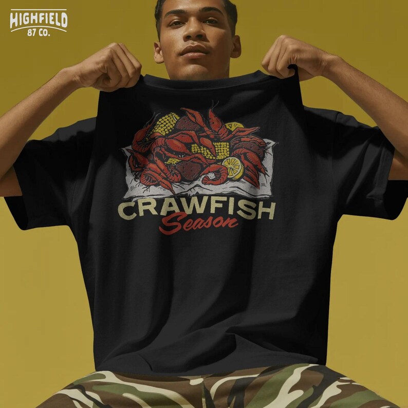 Crawfish Season printable PNG showcasing a traditional southern boil with crawfish, corn on the cob, and lemon wedges for summer themed apparel.