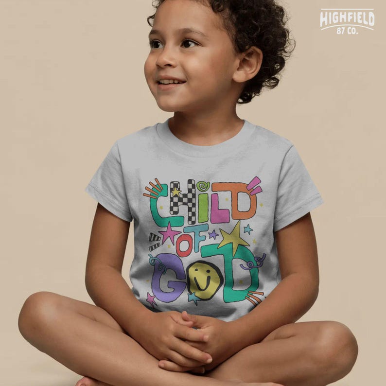 Boys faith PNG showing colorful Child Of God lettering with stars and fun doodle accents for Christian kids shirts.