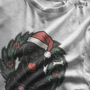 Cute Christmas labrador PNG file featuring black lab in wreath with festive decorations. Great for sublimation or pet lover holiday gifts.