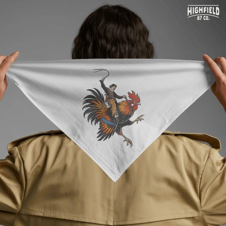Cowboy humor PNG artwork showing a western rider on a rooster with bold orange and black feathers and dynamic movement for novelty apparel.