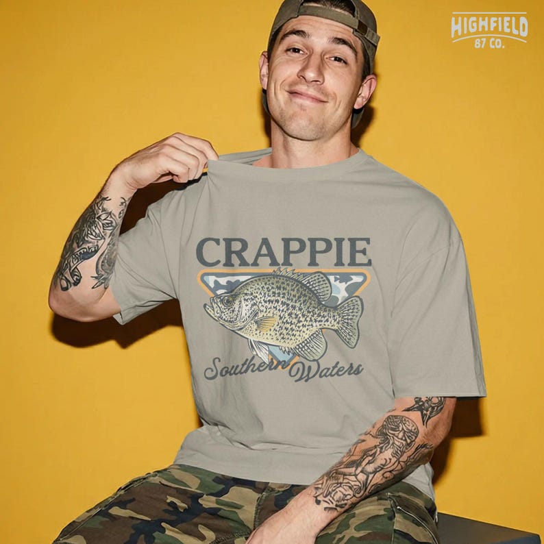 Fisherman PNG design with a crappie fish, southern waters text, and outdoor fishing badge style for summer fishing shirts and digital downloads.