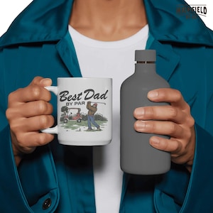 Bigfoot PNG design featuring a Sasquatch golfer, red cap, golf cart, and Best Dad By Par phrase for funny golf dad digital shirt projects.