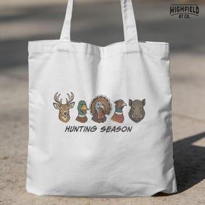 Hunting season shirt PNG featuring deer, mallard, turkey, pheasant, and boar heads for hunters and outdoor sportsmen.