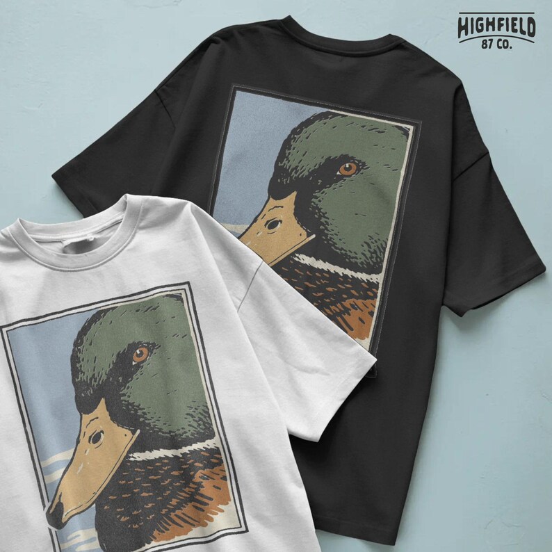 Waterfowl hunting style mallard duck head graphic in profile, showcasing the classic green head drake with dark chest and layered feather detail. The framed composition gives it a badge style appearance, making it perfect for hunting shirt design, sublimation prints, and mallard duck PNG digital download collections.