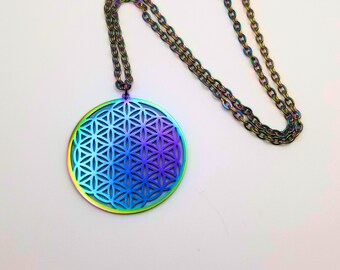 May include: A rainbow iridescent stainless steel necklace with a round pendant featuring a flower of life design.