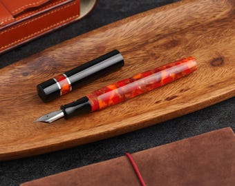 Handcrafted fountain pen made from ebonite and resin with metal rings